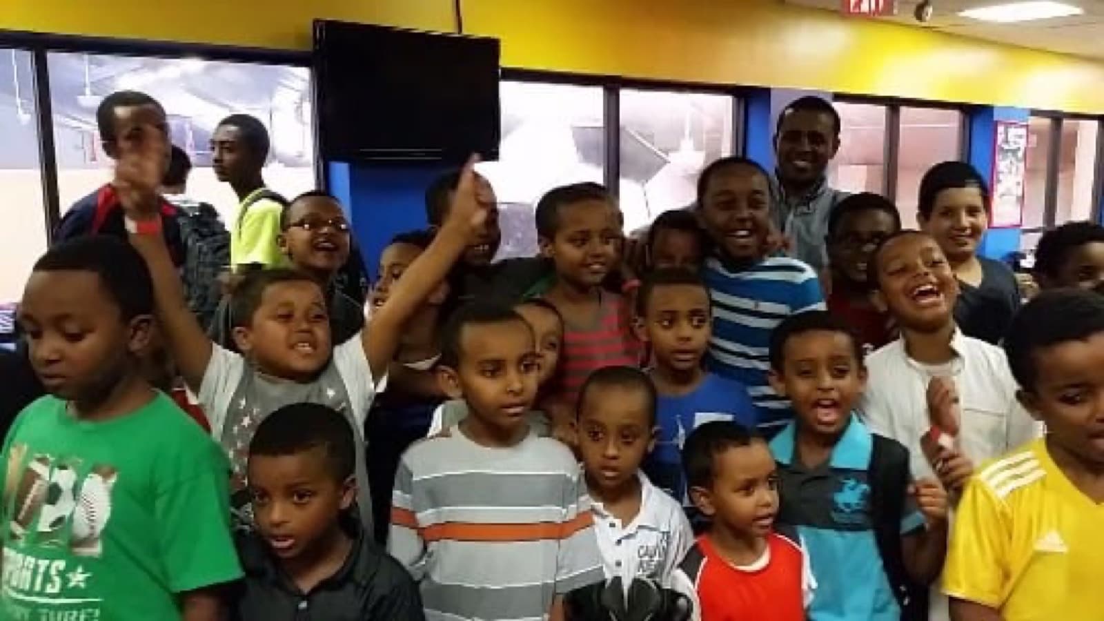 Boys cheering together at a Selam Foundation youth gathering